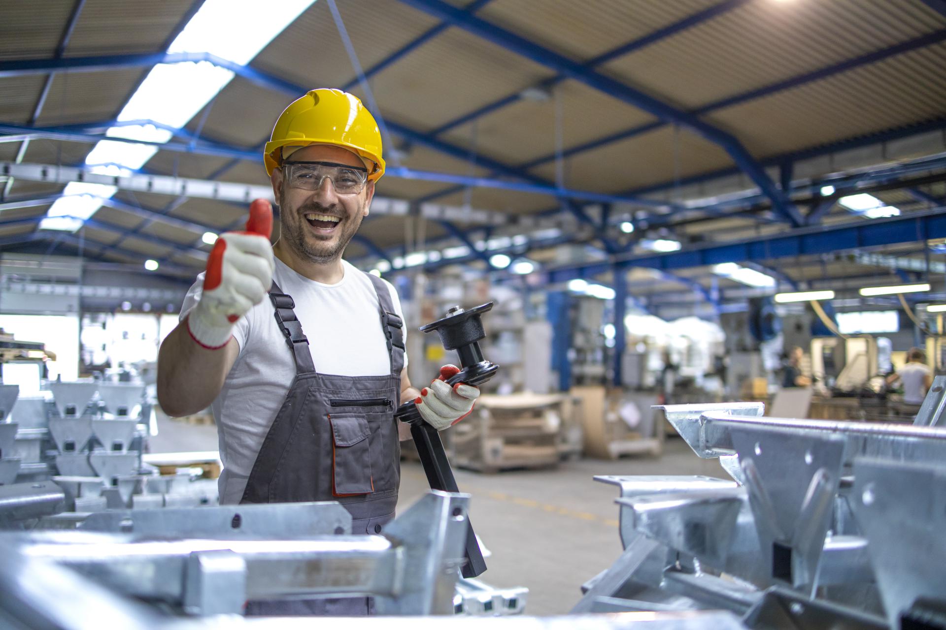 981portrait-of-factory-worker-in-protective-equipment-holding-thumbs-up-in-production-hall.jpg